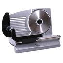 A front-on view of a silver-colored electric meat slicer. The slicer has a large, circular, serrated blade on the right side. To the left of the blade is a sliding tray with a black handle and a clear, textured plastic food press. The base of the machine is also silver and features a brand name, "Dominion," in a small, stylized font on the front.