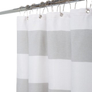 Elegant Elle Paris shower curtain with a textured white fabric and modern light gray stripes, suspended by silver hooks on a shower rod.