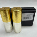 A set of two cylindrical salt and pepper shakers with a unique two-tone design. The top half is matte gold with a hammered texture, and the bottom half is matte silver with a matching hammered texture.