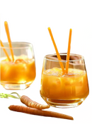 2 clear water glasses, filled halfway with carrot drink, displayed on a white background.