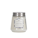 A small, clear glass jar candle with white wax, a silver metal lid, and a decorative label featuring the scent 'Classic Linen.'