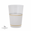 Elegant clear plastic tumbler with a white body and two thin metallic gold rims. Perfect for upscale events, weddings, and parties. Luxe Party NYC branding in the corner.