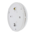 An image of a First Alert Smoke and Carbon Monoxide Alarm, a round, white device with a prominent "First Alert" logo and text reading "SMOKE AND CO ALARM." It features a central circular button or vent with a rectangular opening on the left and a narrow slit on the right. The device is shown at a slight angle against a plain white background.