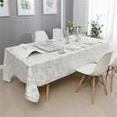 The silver mosaic velvet tablecloth elegantly spread over a rectangular dining table