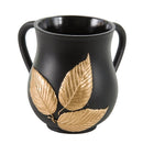 A black ritual washing cup with two curved handles and three large, ornate gold-colored leaf appliqués on the body.