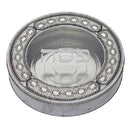 A round tin matzah storage container with a silver finish, a clear top, an ornate lace pattern border, and Hebrew text visible through the lid.