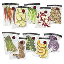 ZWILLING Fresh & Save Vacuum Sealer Bags, a set of nine transparent bags filled with various fresh produce like carrots, pineapple, lettuce, sliced apples, granola, asparagus, mushrooms, broccoli, melon slices, and red cabbage, each featuring a red vacuum seal valve.
