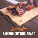 Yukon Glory BBQ 'N Serve Premium 7-piece set, featuring a grill basket, searing pan, bamboo cutting board, and orange serving tray.