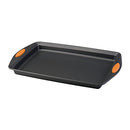 A gray 10" x 15" Rachael Ray nonstick cookie sheet with orange silicone grip handles shown on a white background.