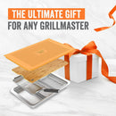 Yukon Glory BBQ 'N Serve Premium 7-piece set, featuring a grill basket, searing pan, bamboo cutting board, and orange serving tray.