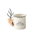 A 16-ounce speckled white ceramic mug designed to look like enamelware. It is printed with the text 'We go together like cocoa + s'mores' and comes with a small, black metal marshmallow roasting fork.