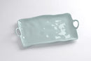 A large, rectangular serving platter with an irregular, wavy rim, integrated loop handles, and a solid aqua blue color.