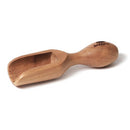 A small, light brown olive wood scoop with a shovel-like end and a rounded handle, featuring "BERARD" engraved on the handle.