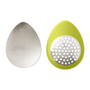 Green oval-shaped Chef'n garlic grater with a stainless steel grating surface.