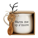 A boxed three-piece set featuring a large, white 21-ounce ceramic mug printed with the text 'Warm me up s'more', a wooden spoon, and a black metal roasting fork.