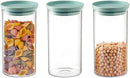 Set of three large clear glass Godinger food storage canisters with airtight lids, stacked neatly on a white background.