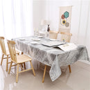 A forest grey jacquard print rectangular tablecloth by Majestic Giftware, neatly spread on a table
