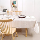 Rectangular gold jacquard zigzag tablecloth laid flat on a table.