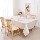 Rectangular gold jacquard zigzag tablecloth laid flat on a table.